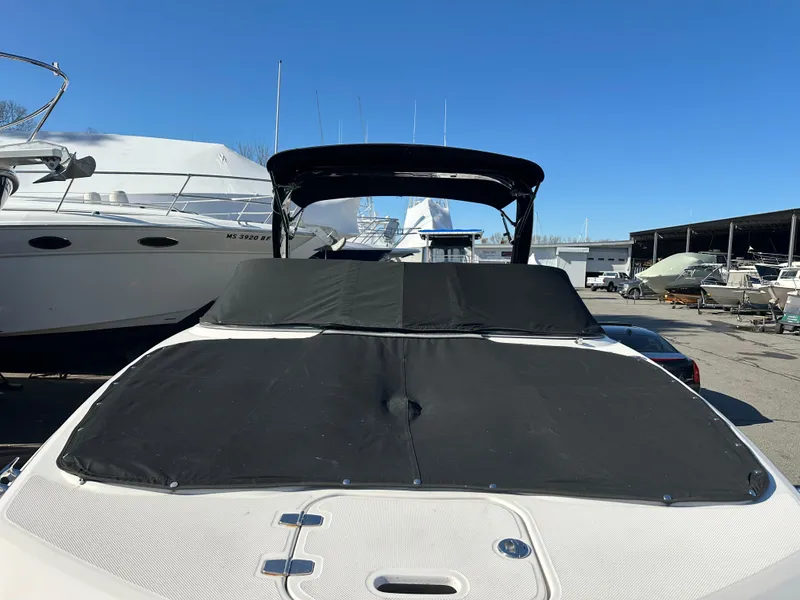 Slide: The Image of 2018 Regal 23 OBX boat with black cover in marina setting. - 37