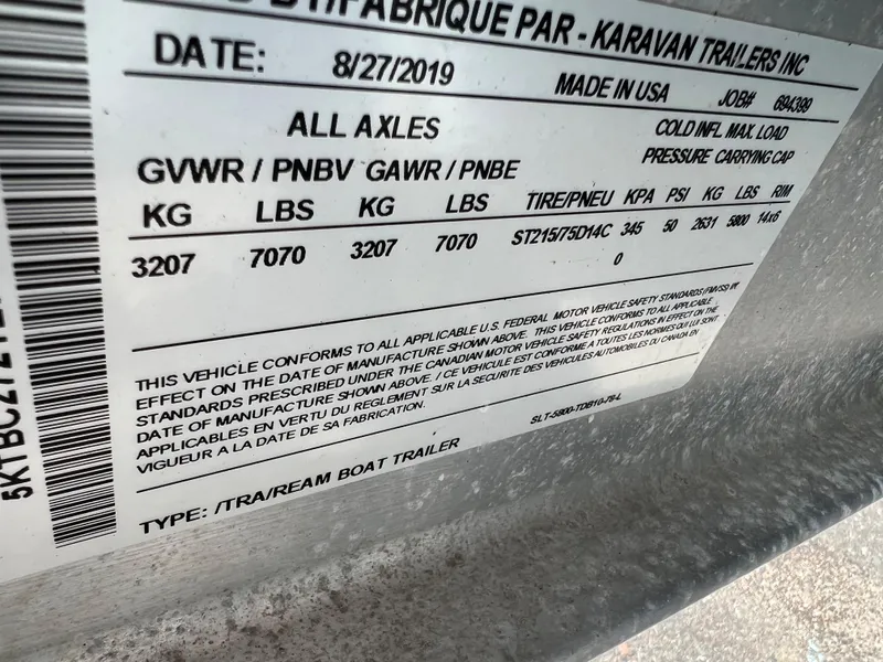 Slide: The Image of Regal 23 OBX 2018 trailer label showing weight specifications and compliance details. - 40