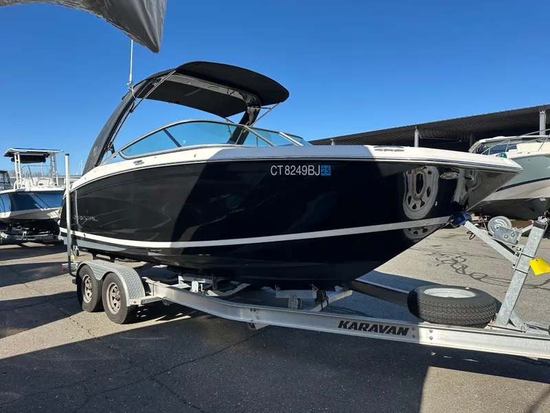 Slide: The Image of 2018 Regal 23 OBX boat on a trailer in a marina setting. - 5