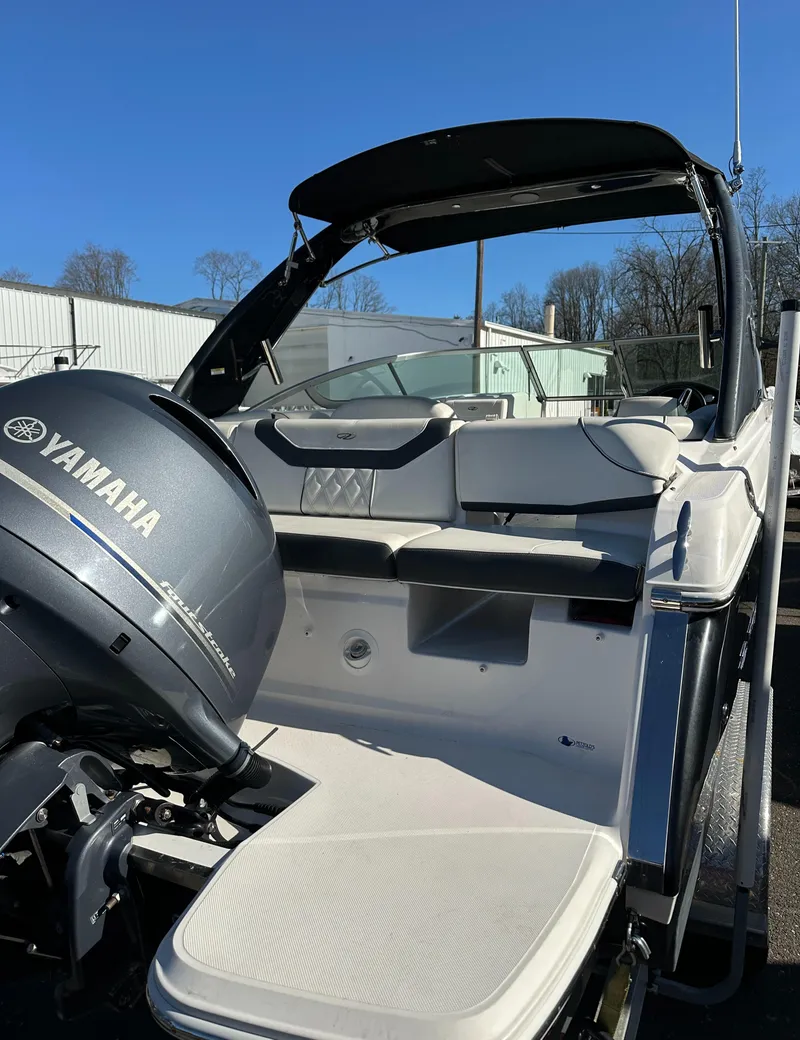 Slide: The Image of 2018 Regal 23 OBX boat with Yamaha outboard motor, docked under clear blue sky. - 6