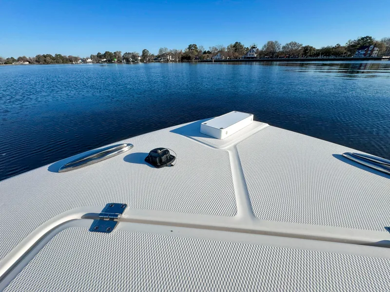 Slide: The Image of Bow view of 2022 Regulator 24 XO boat on calm water. - 13