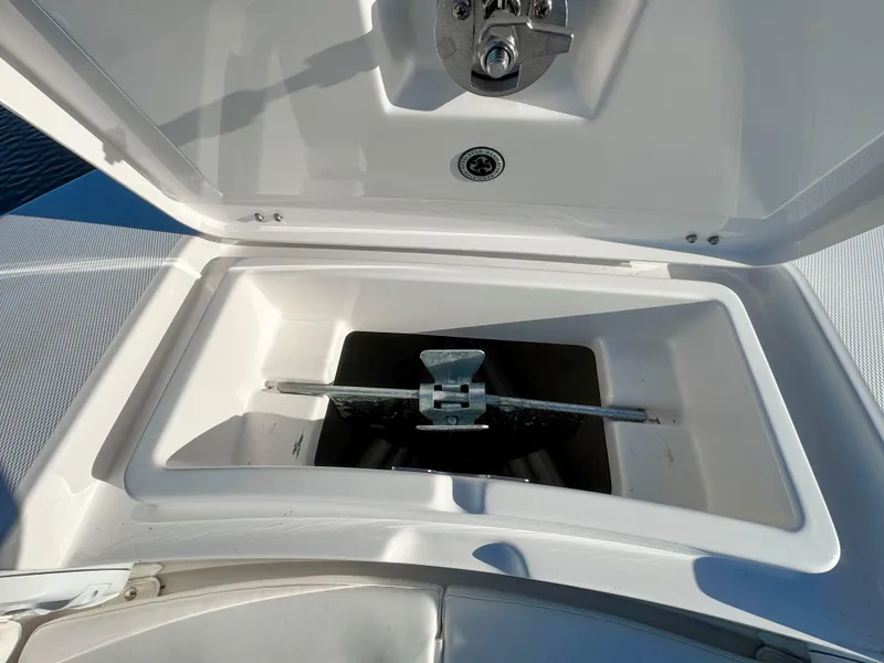 Slide: The Image of Anchor compartment of 2022 Regulator 24 XO boat, open lid, showing anchor storage. - 14
