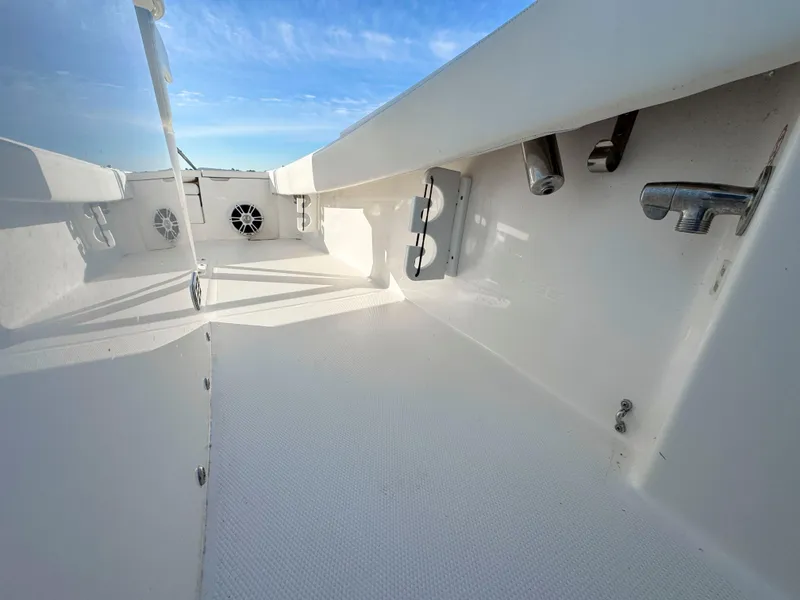 Slide: The Image of 2022 Regulator 24 XO boat interior with white deck and fixtures under blue sky. - 17