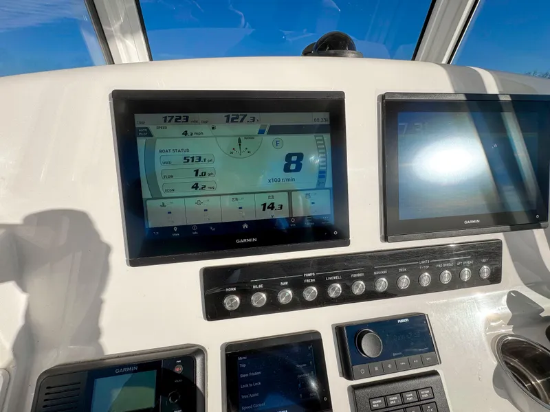 Slide: The Image of Dashboard of 2022 Regulator 24 XO boat with Garmin displays and controls. - 19