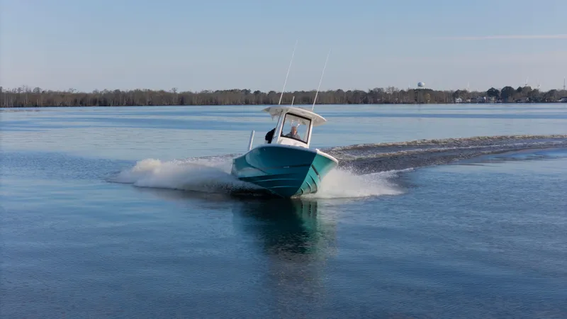 Slide: The Image of 2022 Regulator 24 XO boat cruising on calm water. - 30