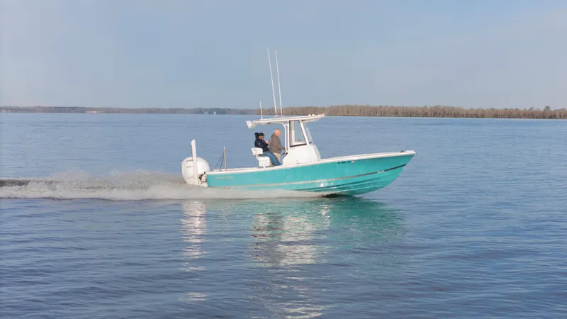 Slide: The Image of 2022 Regulator 24 XO boat cruising on calm water. - 32