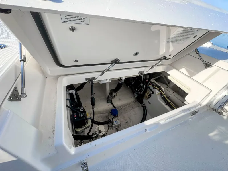 Slide: The Image of Open storage compartment of 2022 Regulator 24 XO boat, showing internal components and wiring. - 8