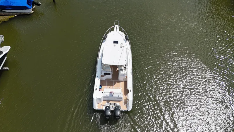 Slide: The Image of Aerial view of 1999 Boston Whaler 28 Conquest boat on calm water. - 17