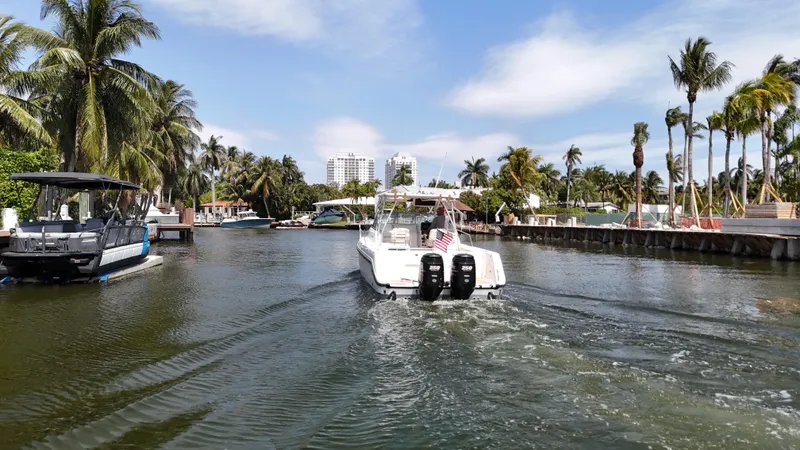 Slide: The Image of Boston Whaler 28 Conquest boat cruising in a tropical canal, 1999 model. - 26
