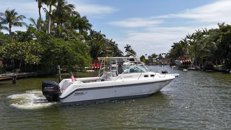 Slide: The Image of 1999 Boston Whaler 28 Conquest cruising on a scenic, tropical waterway. - 28