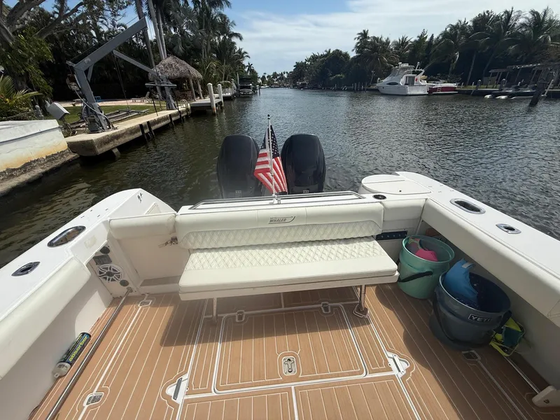 Slide: The Image of 1999 Boston Whaler 28 Conquest boat docked on a scenic canal with palm trees. - 6