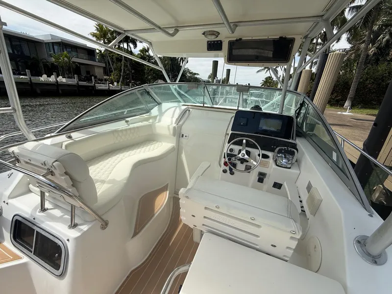 Slide: The Image of 1999 Boston Whaler 28 Conquest boat interior with helm, seating, and navigation equipment. - 7