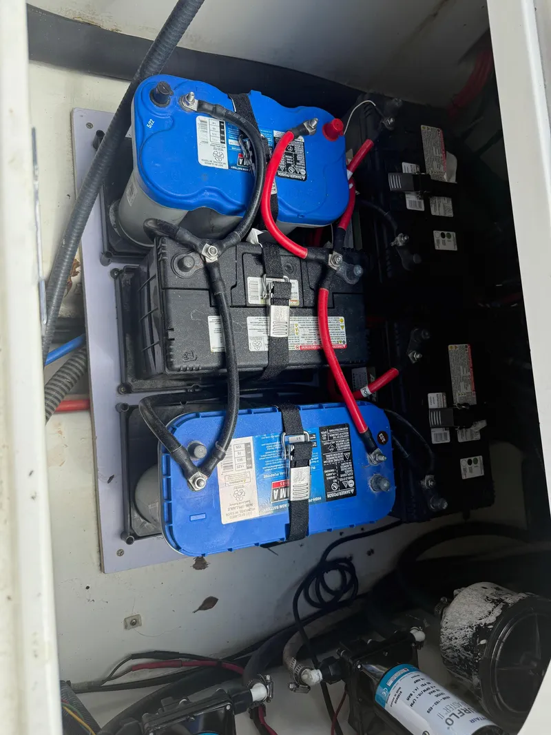 Slide: The Image of Battery compartment of a 1999 Boston Whaler 28 Conquest boat with wiring and connections. - 9