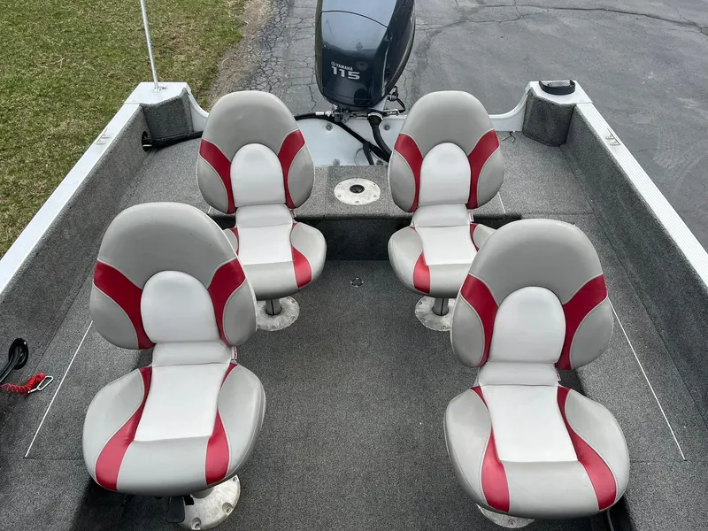 Slide: The Image of 2010 Alumacraft Navigator 175 CS boat interior with four red and white seats. - 10