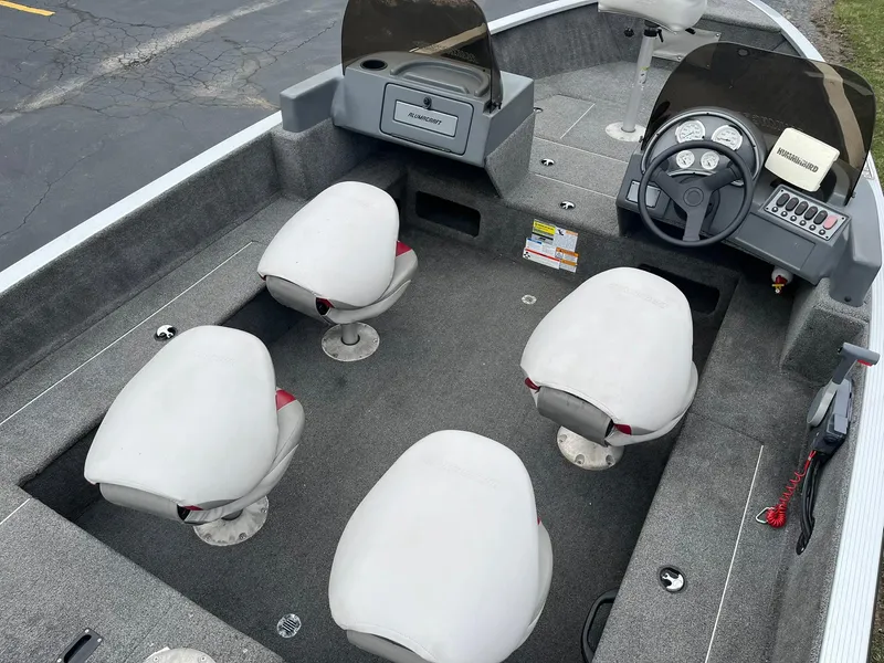 Slide: The Image of 2010 Alumacraft Navigator 175 CS boat interior with four seats and steering console. - 11