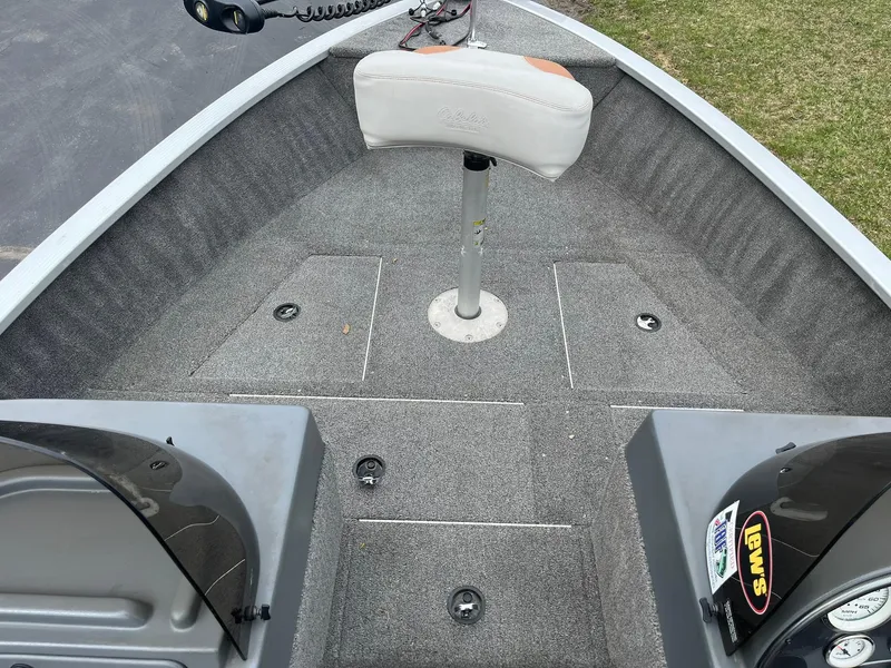 Slide: The Image of 2010 Alumacraft Navigator 175 CS boat interior with gray carpet and swivel seat. - 12