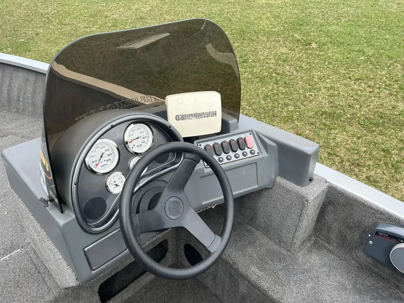 Slide: The Image of 2010 Alumacraft Navigator 175 CS boat dashboard with steering wheel and gauges. - 14