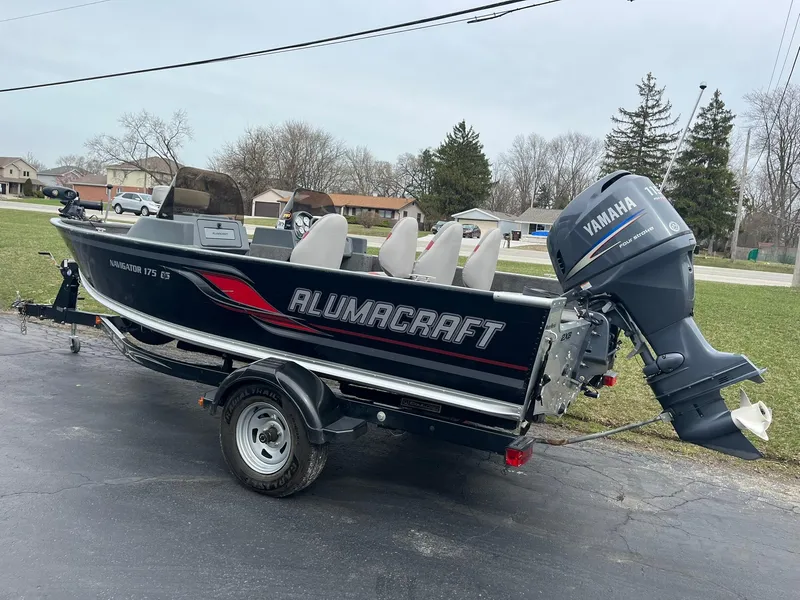 Slide: The Image of 2010 Alumacraft Navigator 175 CS boat with Yamaha outboard motor on a trailer. - 2