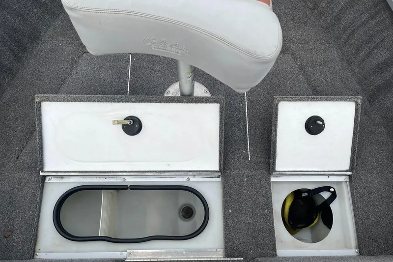 Slide: The Image of 2010 Alumacraft Navigator 175 CS boat interior with storage compartments and seating. - 21