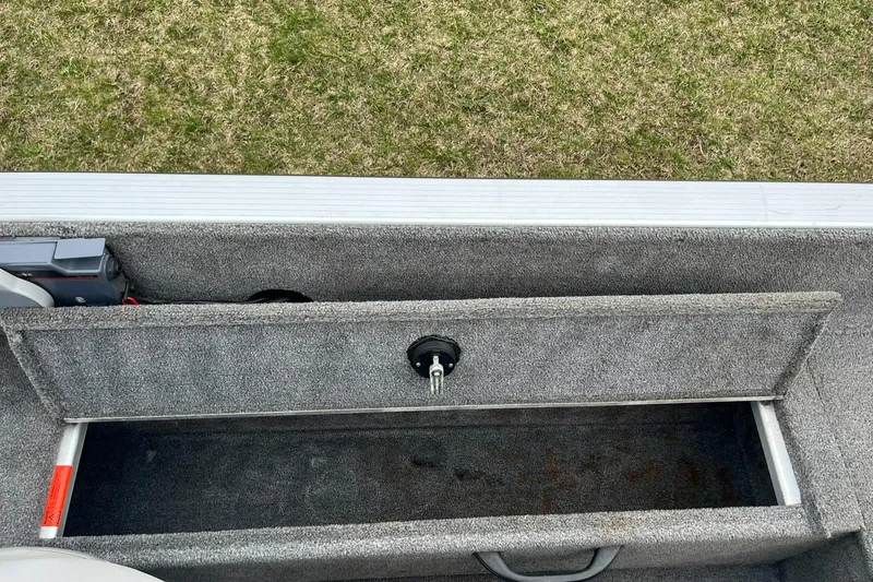 Slide: The Image of 2010 Alumacraft Navigator 175 CS storage compartment with open lid, showing interior space. - 24