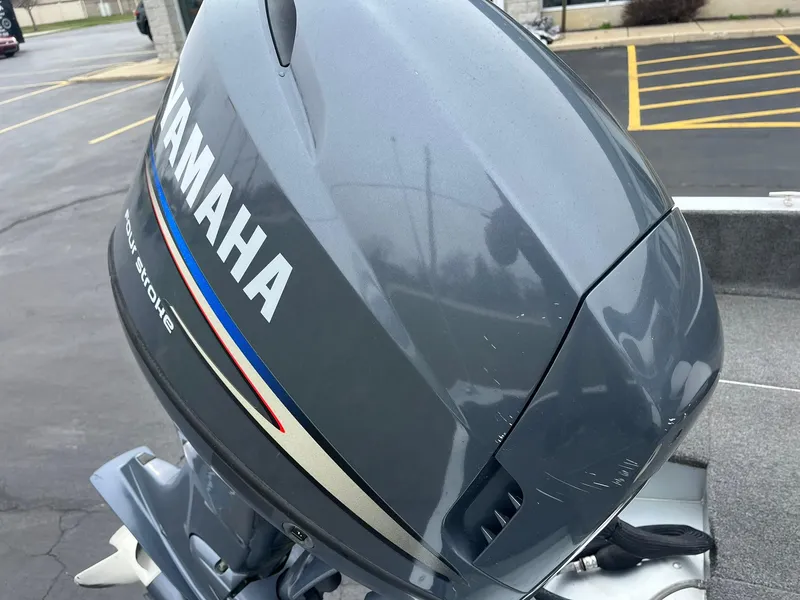 Slide: The Image of Yamaha outboard motor on 2010 Alumacraft Navigator 175 CS boat, parked in lot. - 26