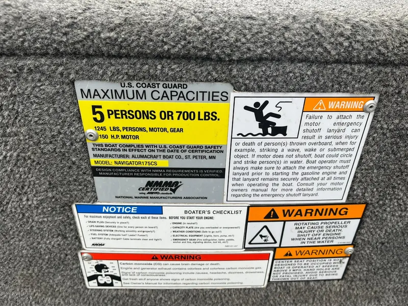 Slide: The Image of Safety label on 2010 Alumacraft Navigator 175 CS boat, showing capacity and warnings. - 28