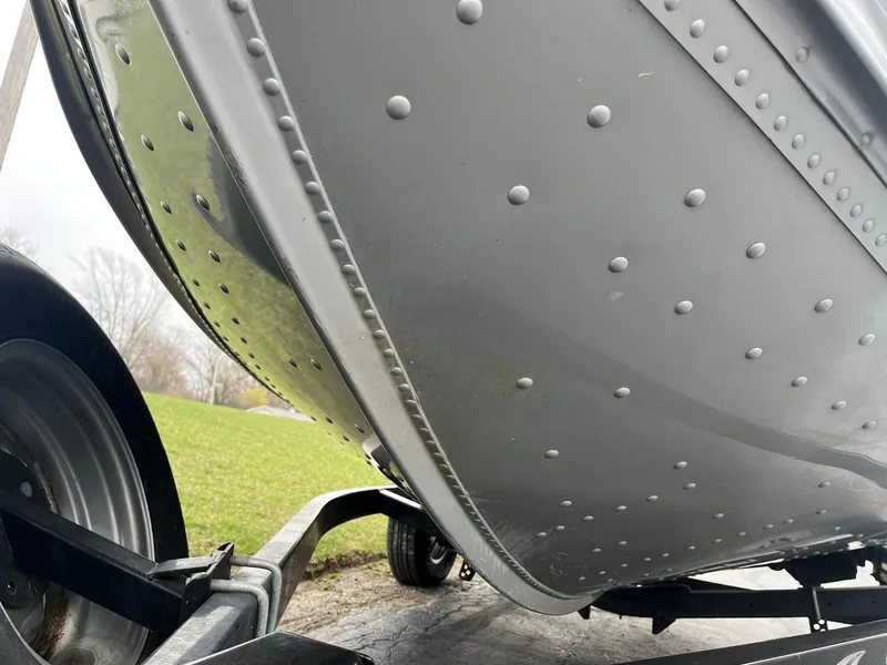 Slide: The Image of 2010 Alumacraft Navigator 175 CS boat on trailer, close-up of riveted hull. - 29