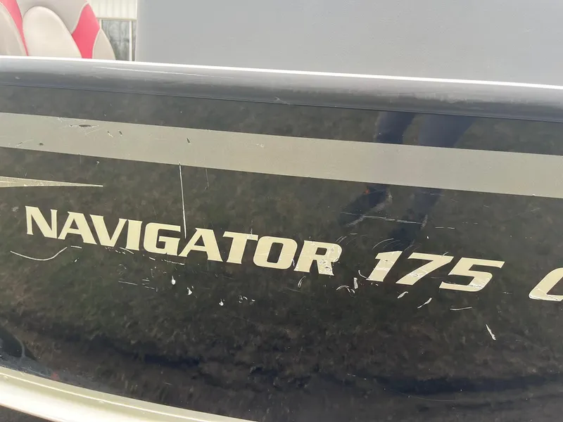 Slide: The Image of 2010 Alumacraft Navigator 175 CS boat with visible scratches on the side. - 32