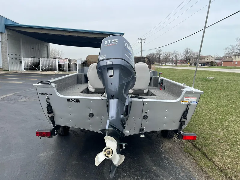 Slide: The Image of 2010 Alumacraft Navigator 175 CS boat with Yamaha 115 outboard motor, parked outdoors. - 5