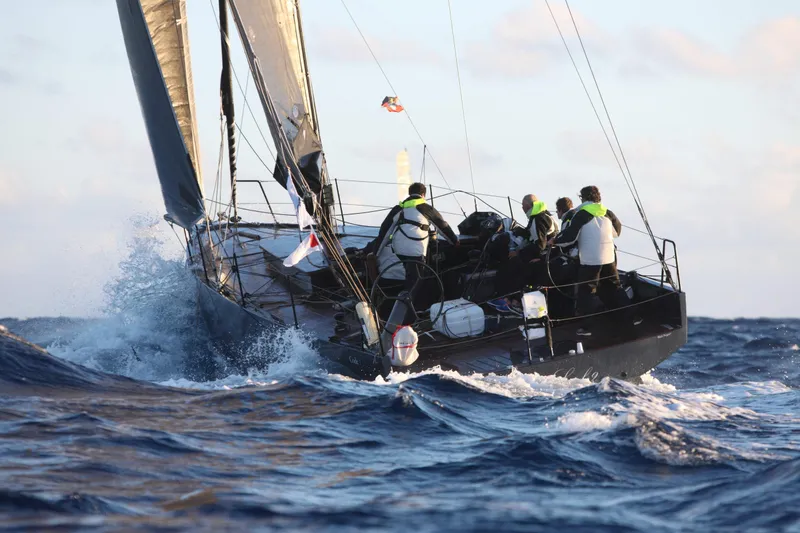 Slide: The Image of Sailboat navigating rough seas, crew onboard, Black Pepper CODE 1, 2025 model. - 11