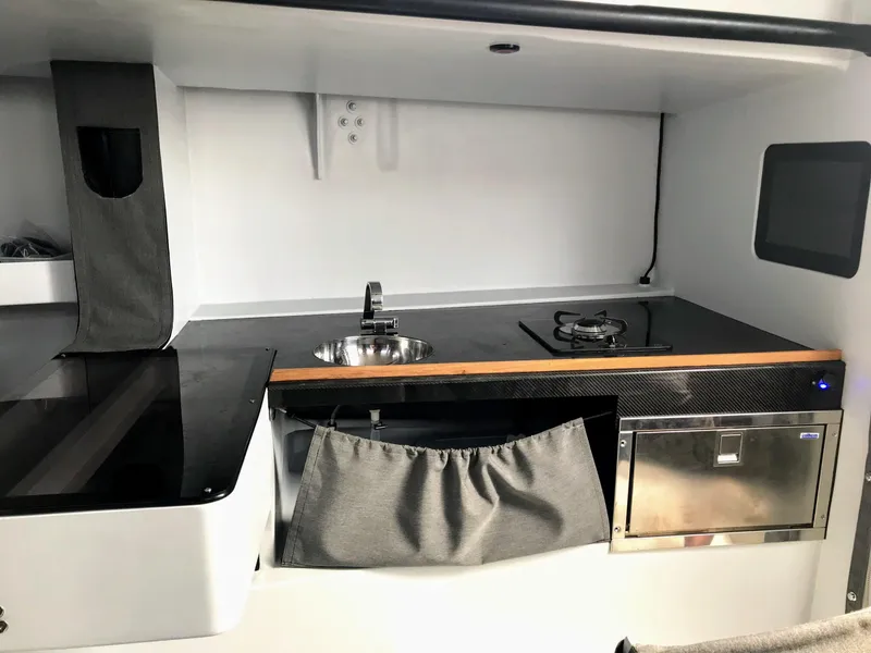 Slide: The Image of Compact kitchen setup in Black Pepper CODE 1, 2025 model, featuring sink and stove. - 16