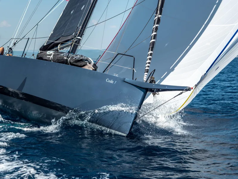 Slide: The Image of Sleek Black Pepper CODE 1 sailboat cutting through ocean waves, 2025 model. - 6