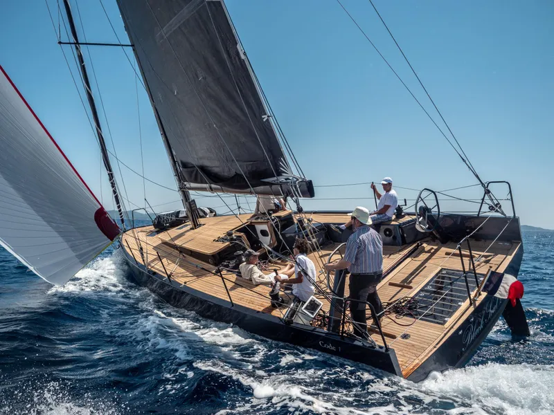 Slide: The Image of Sailing yacht Black Pepper CODE 1, 2025 model, navigating ocean waters with crew onboard. - 7