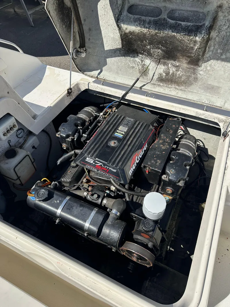 Slide: The Image of 1998 Pursuit 2460 Denali boat engine compartment with MerCruiser engine visible. - 15