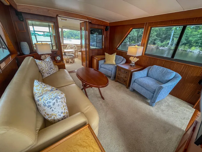 Slide: The Image of Luxurious interior of 1984 Hatteras 53 Motoryacht with elegant seating and scenic views. - 10
