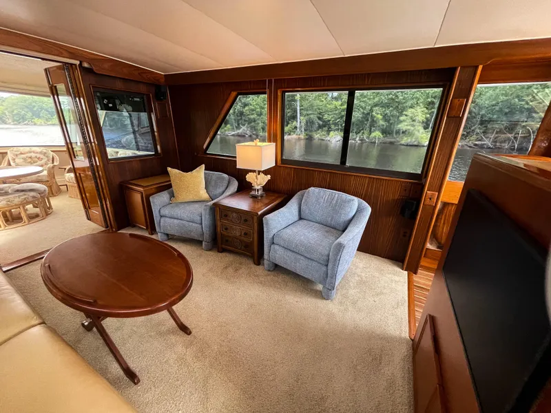 Slide: The Image of Luxurious interior of 1984 Hatteras 53 Motoryacht with elegant seating and scenic window views. - 11