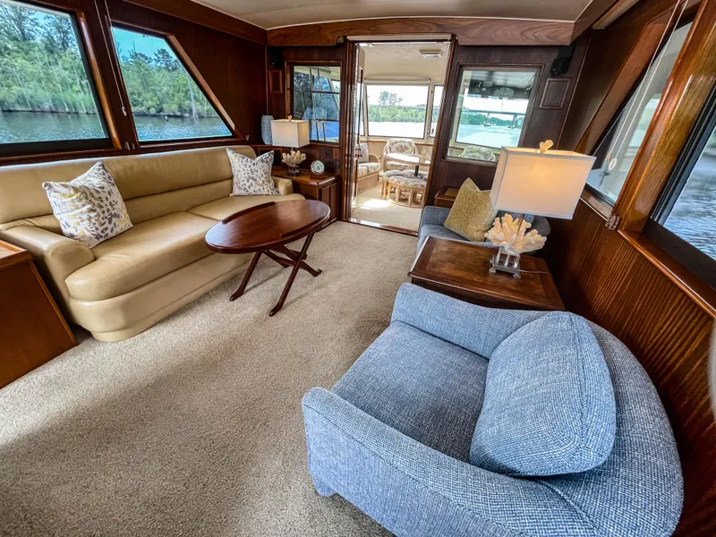 Slide: The Image of Luxurious interior of 1984 Hatteras 53 Motoryacht with elegant seating and decor. - 12