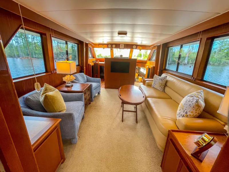 Slide: The Image of Luxurious interior of 1984 Hatteras 53 Motoryacht with elegant seating and large windows. - 13