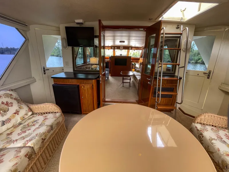 Slide: The Image of Interior of 1984 Hatteras 53 Motoryacht with elegant seating, table, and TV. - 16
