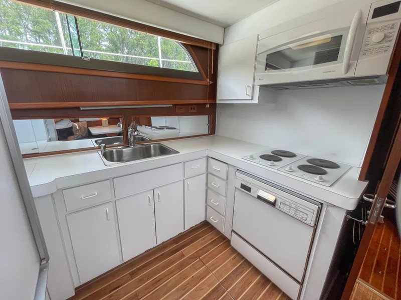 Slide: The Image of 1984 Hatteras 53 Motoryacht kitchen with modern appliances and wood flooring. - 22
