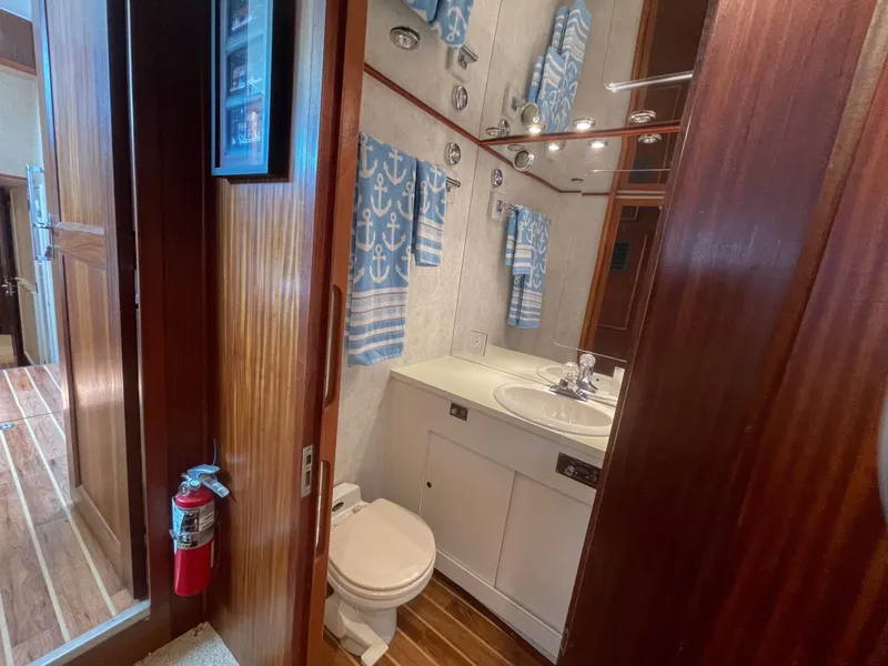 Slide: The Image of 1984 Hatteras 53 Motoryacht bathroom with nautical decor, wooden accents, and compact design. - 28