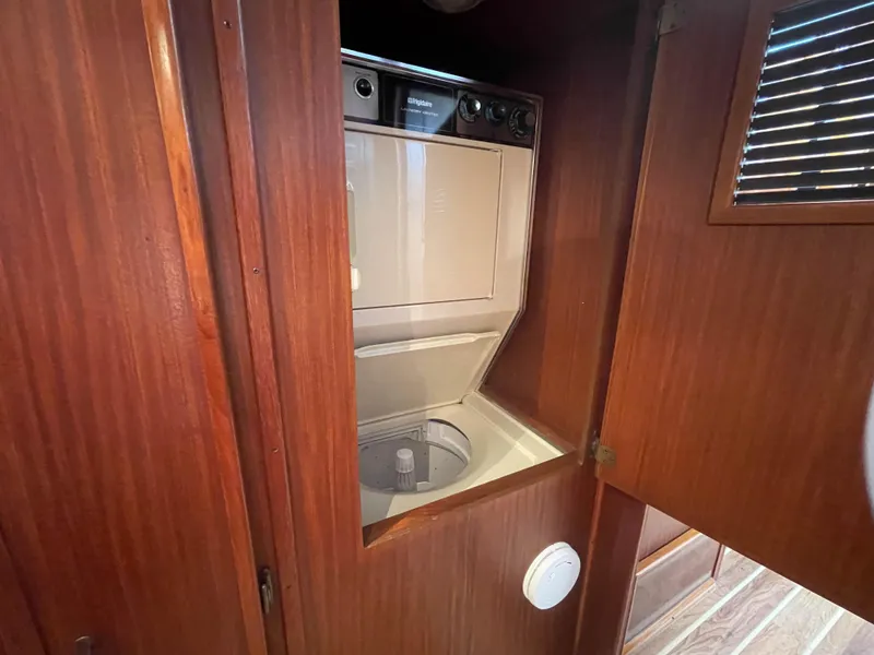 Slide: The Image of 1984 Hatteras 53 Motoryacht interior with built-in laundry appliance in wooden cabinet. - 30