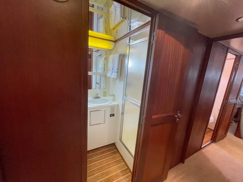 Slide: The Image of 1984 Hatteras 53 Motoryacht bathroom with wooden doors and compact shower. - 37