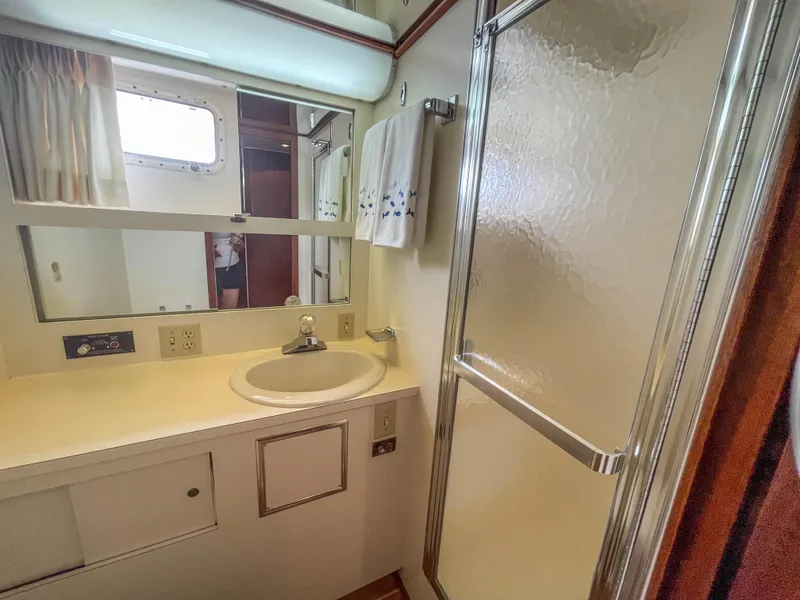Slide: The Image of 1984 Hatteras 53 Motoryacht bathroom with sink, mirror, and shower. - 38