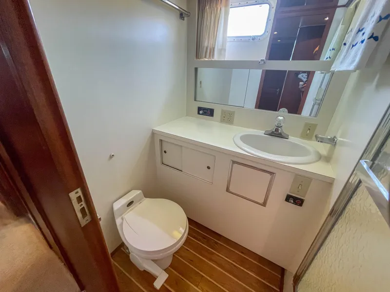 Slide: The Image of 1984 Hatteras 53 Motoryacht bathroom with sink, toilet, and wood flooring. - 39