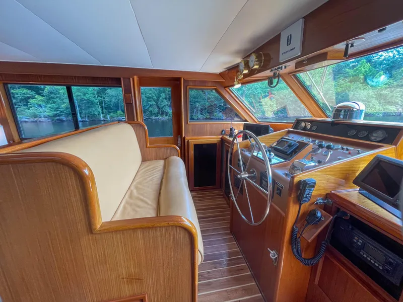 Slide: The Image of 1984 Hatteras 53 Motoryacht helm with wooden interior and large windows. - 8