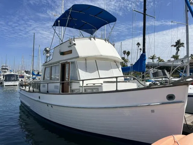The Image of 1981 Grand Banks 36 Classic yacht docked at marina under blue sky. - 1