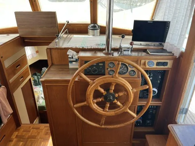Slide: The Image of 1981 Grand Banks 36 Classic helm with wooden wheel and navigation instruments. - 10