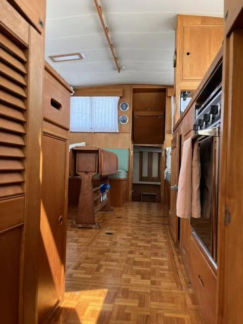 Slide: The Image of Interior of 1981 Grand Banks 36 Classic yacht, featuring wooden cabinetry and parquet flooring. - 16