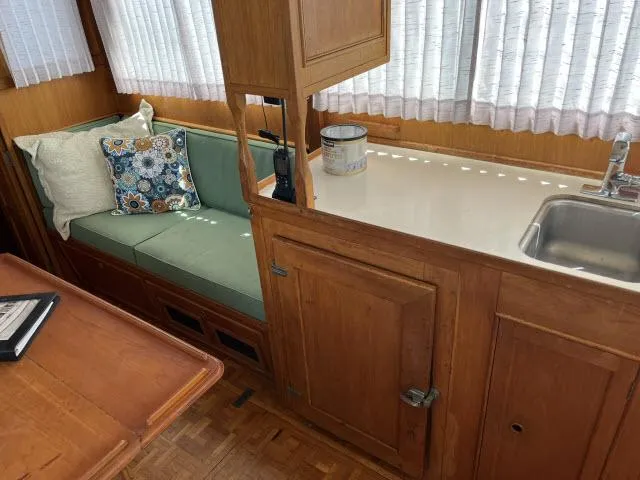 Slide: The Image of Interior of 1981 Grand Banks 36 Classic with wooden cabinetry and cozy seating area. - 18